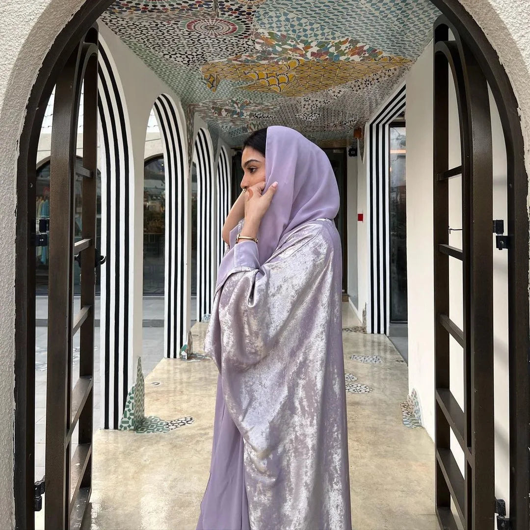 تقدم هذه العباءة الفاخرة بلون بني داكن لامع تصميمًا مستوحى من الأزياء التركية،